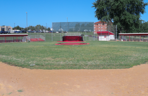 A photo of a current district baseball field, which has safety issues due to the field positioning and sunlight.