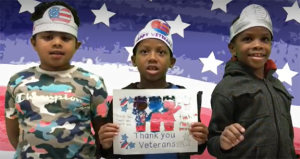 Students with Thank You Veterans poster.