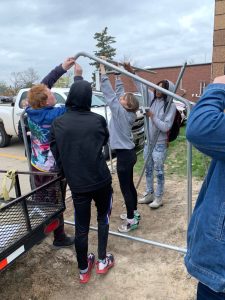 Students building chicken coop for our school.