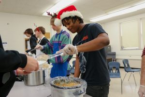 Students serving food at our Holiday Feast.